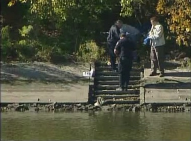 Officials retrieve body from river.