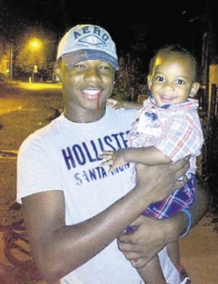 Marlon Barber Jr., 15, with his 1-year-old brother, Shannon. (Courtesy Telegraph-Herald)